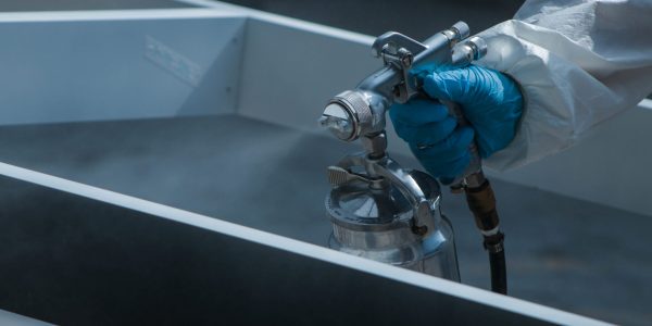 closeup-shot-worker-protective-gloves-painting-wooden-details