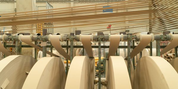 Paper tube cores, steel metal machine engine, technology manufacturer in operation process in industry manufacturing plant factory. Raw product equipment. Cardboard cargo in workshop warehouse