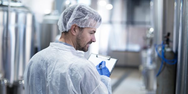 Technologist controlling production in factory.